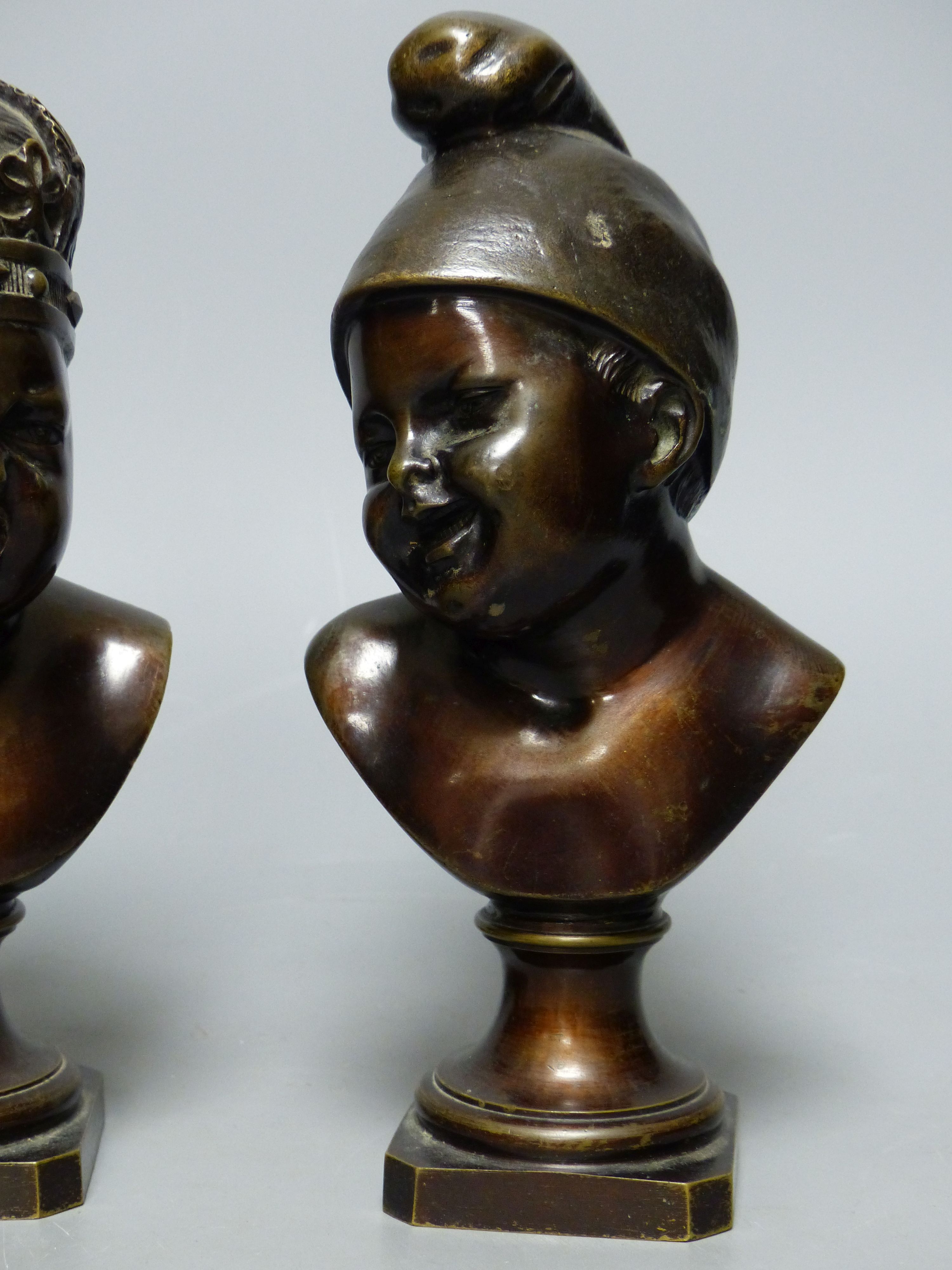 A small bronze bust of a child wearing a crown and another small bronze bust of a child, tallest 22cm H 22cm